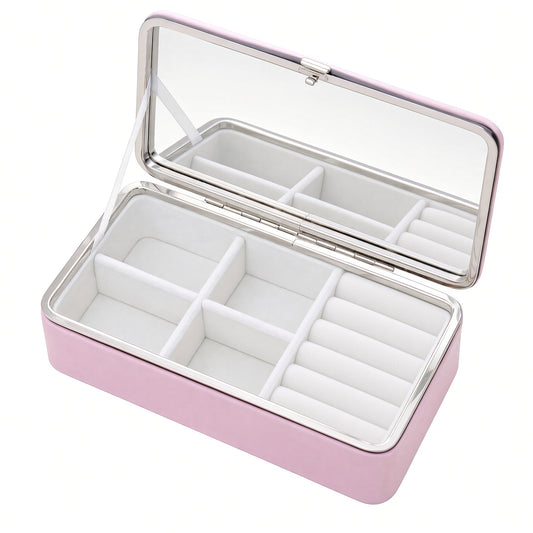 Pink travel jewelry box open with mirror, four compartments and right-side ring rolls