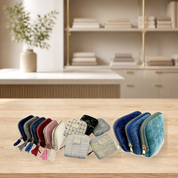 Custom jewelry pouches with detailed fabrics on a clean packaging counter