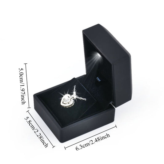Black LED light pendant and earring box shown open with 6.3 by 5.8 by 5.0 cm dimensions