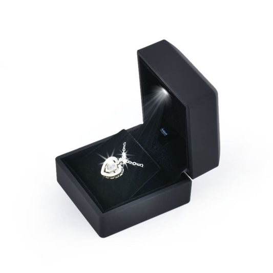 Open black LED light pendant and earring box displaying a pendant