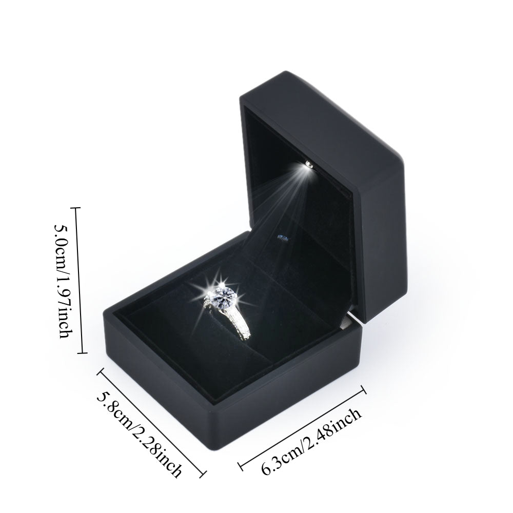 Black LED light ring box shown open with 6.3 by 5.8 by 5.0 cm dimensions