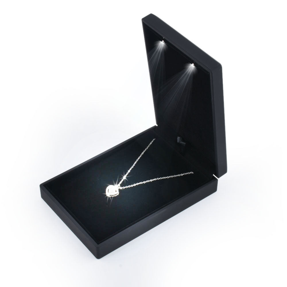 Open black LED light small necklace box displaying a pendant necklace