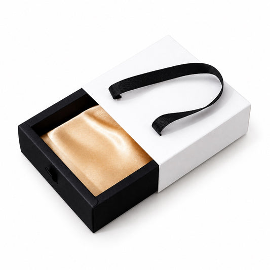 Custom black and white foldable drawer jewelry box with satin insert and ribbon handle on pure white background