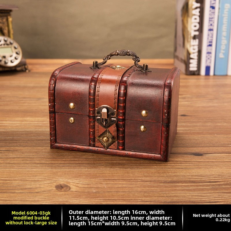 Large reddish brown wooden chest with ornate handle and buckle