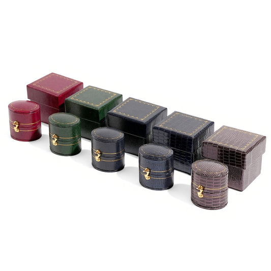 Five closed oval jewelry boxes and five square boxes in assorted colors and textures