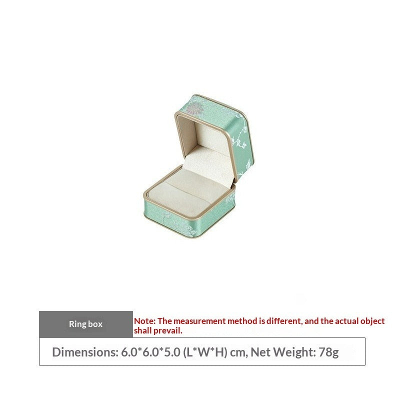 Open mint green floral ring box with ivory ring slot