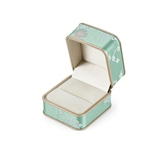 Open mint green floral ring box with ivory ring slot