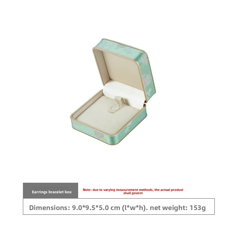 Open mint green floral bangle box with ivory fabric holder