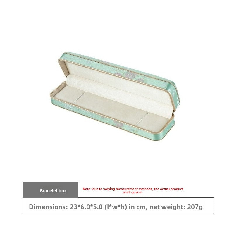 Long mint green floral bracelet box open at a three-quarter angle