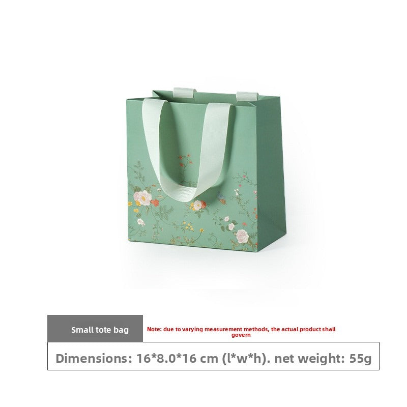 Small mint green floral gift bag with ivory ribbon handles