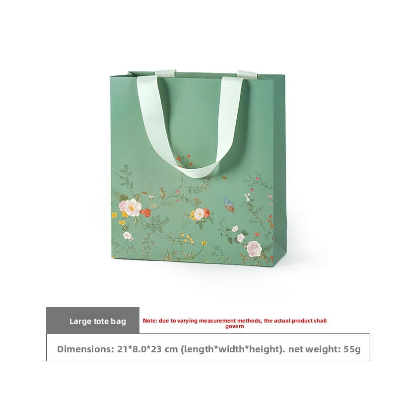 Large mint green floral gift bag with ivory ribbon handles