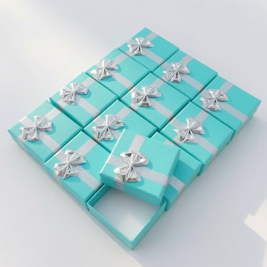 Lake blue paper ring boxes with silver ribbon bows in a wholesale set