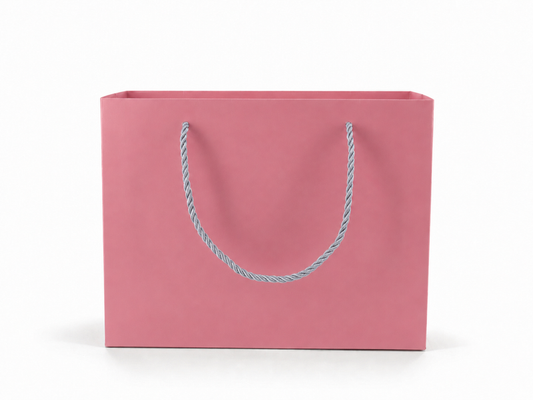 Front view of pink jewelry store gift tote bag with rope handles, 10.25 × 4.25 × 7.75 in